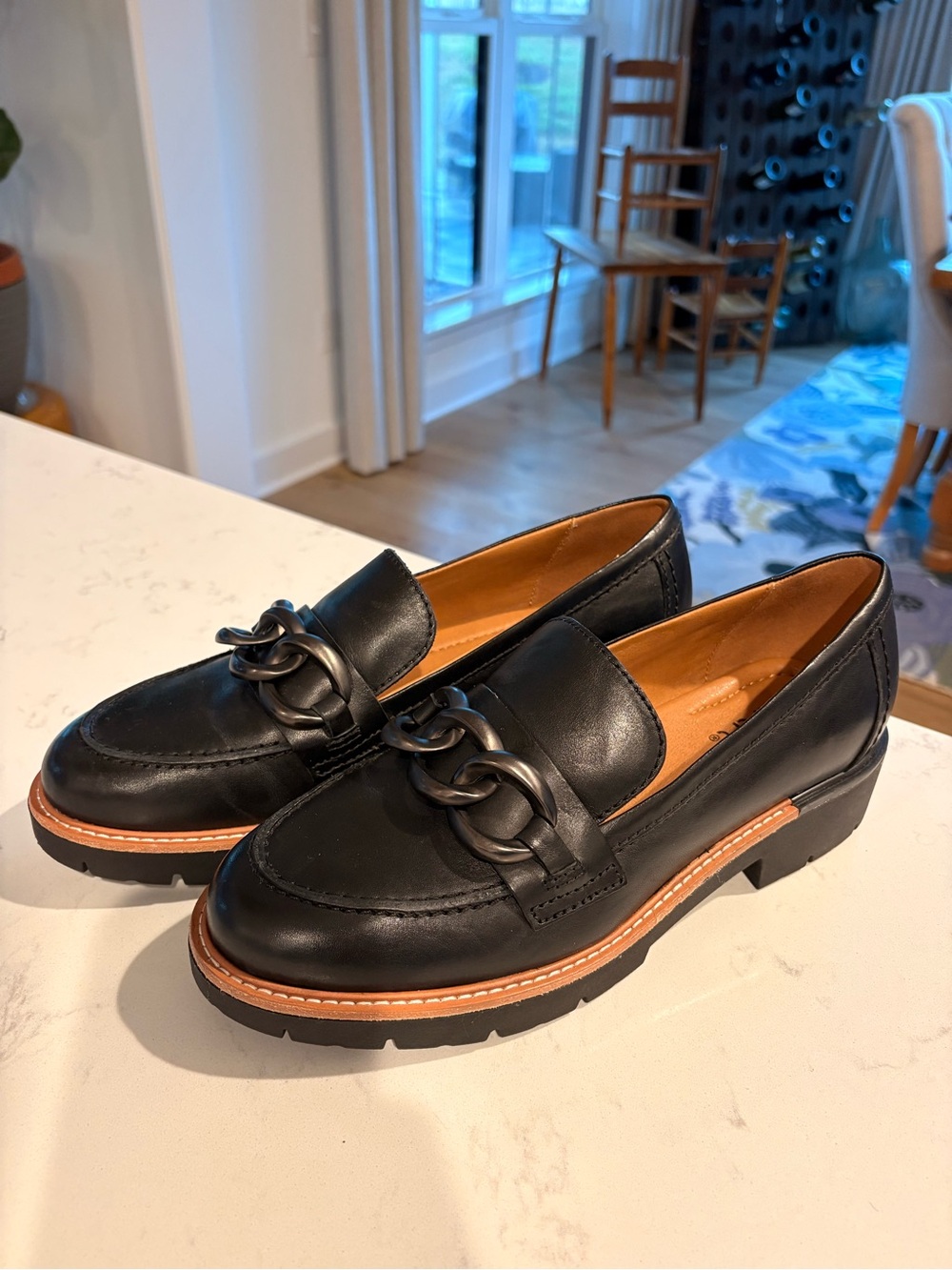 Earth Black Leather Loafers with Brown Trim and Chain Accent